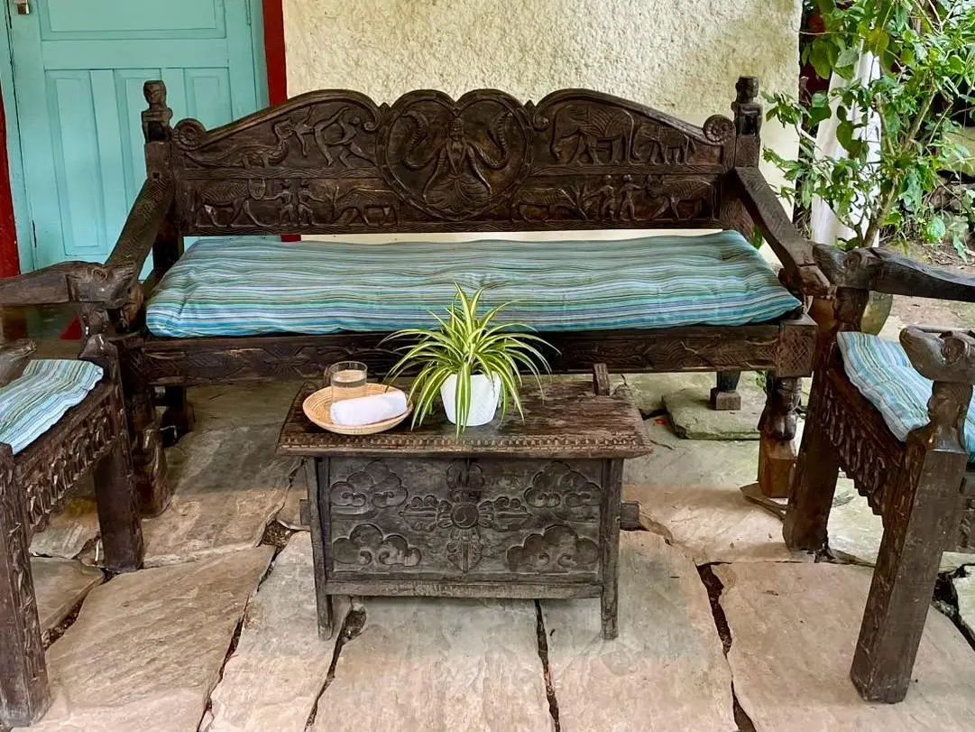 Carved Newari wooden bench in the garden