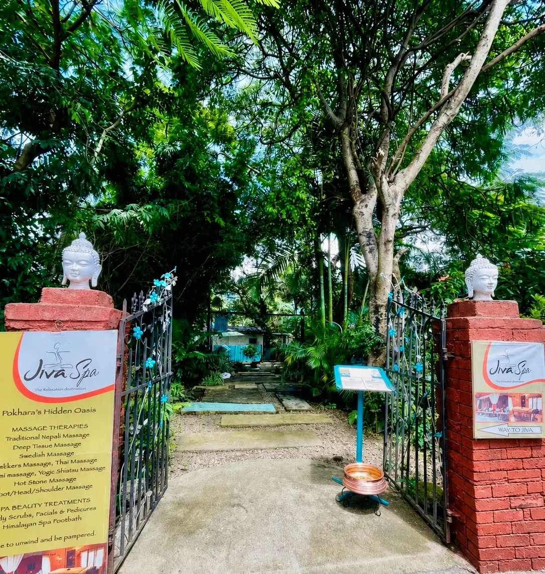 The entrance gate to Jiva Spa with its signs and garden path