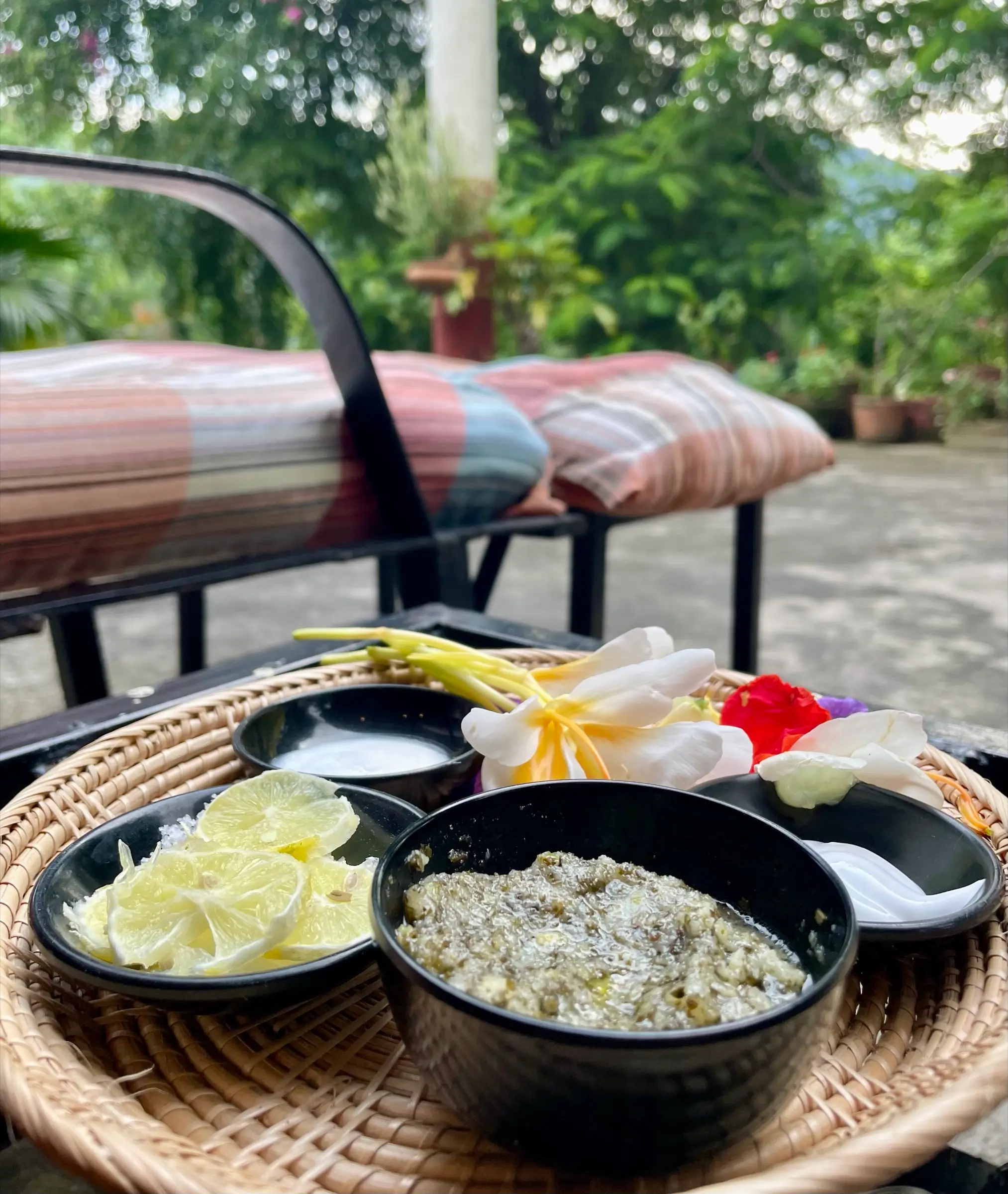 Tray of natural scrub ingredients and fresh flowers