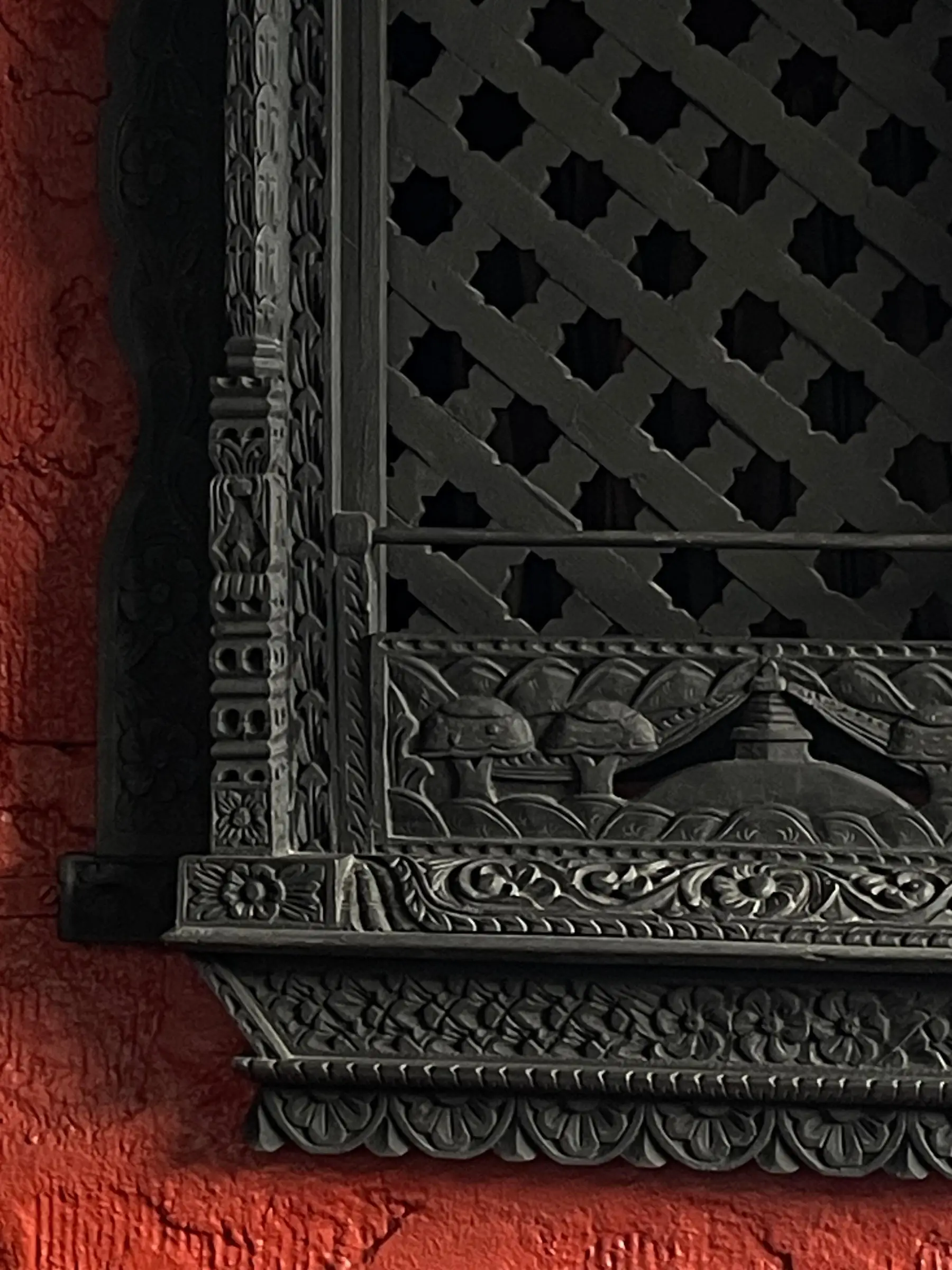 Carved wooden lattice window in traditional Nepali style