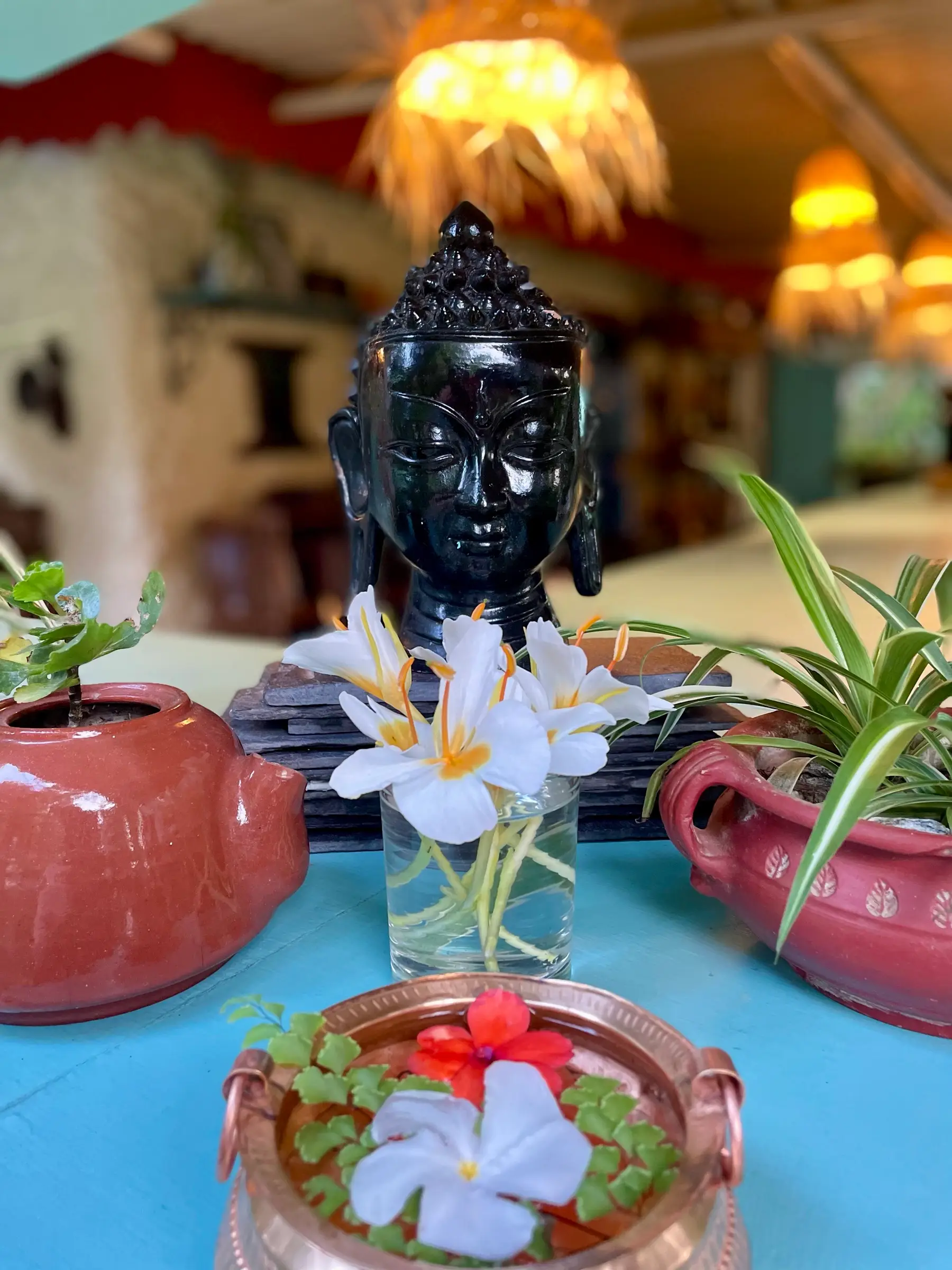 Fresh flowers and a Buddha head at the Jiva Spa reception